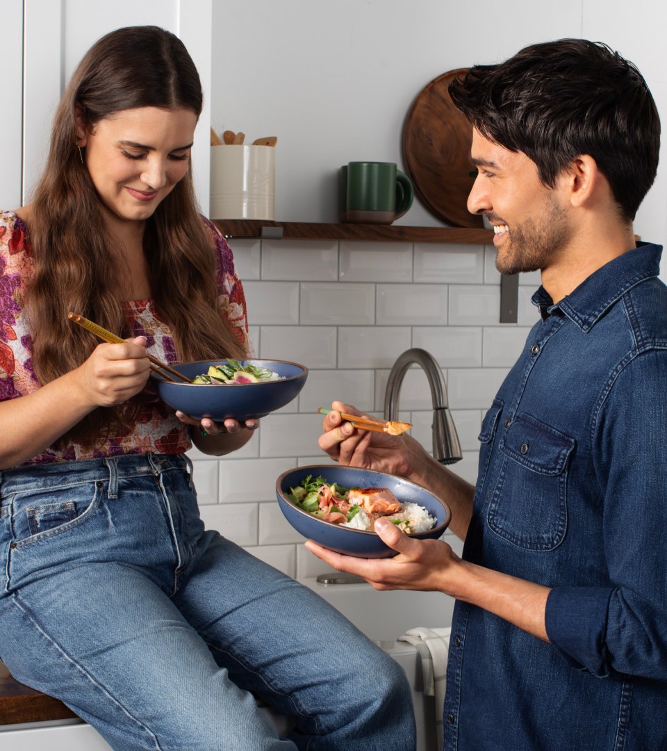 Man and woman eating in kitchen